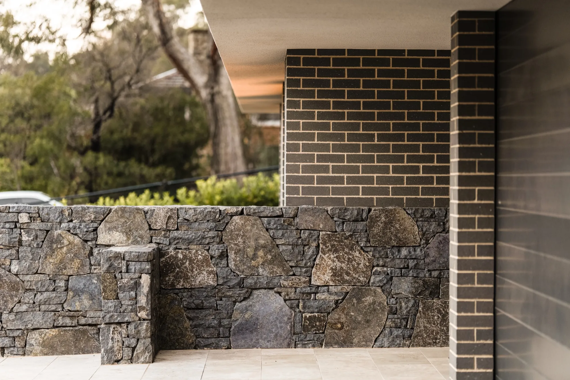 Stone feature wall and dark brick entry at the Hackett new build