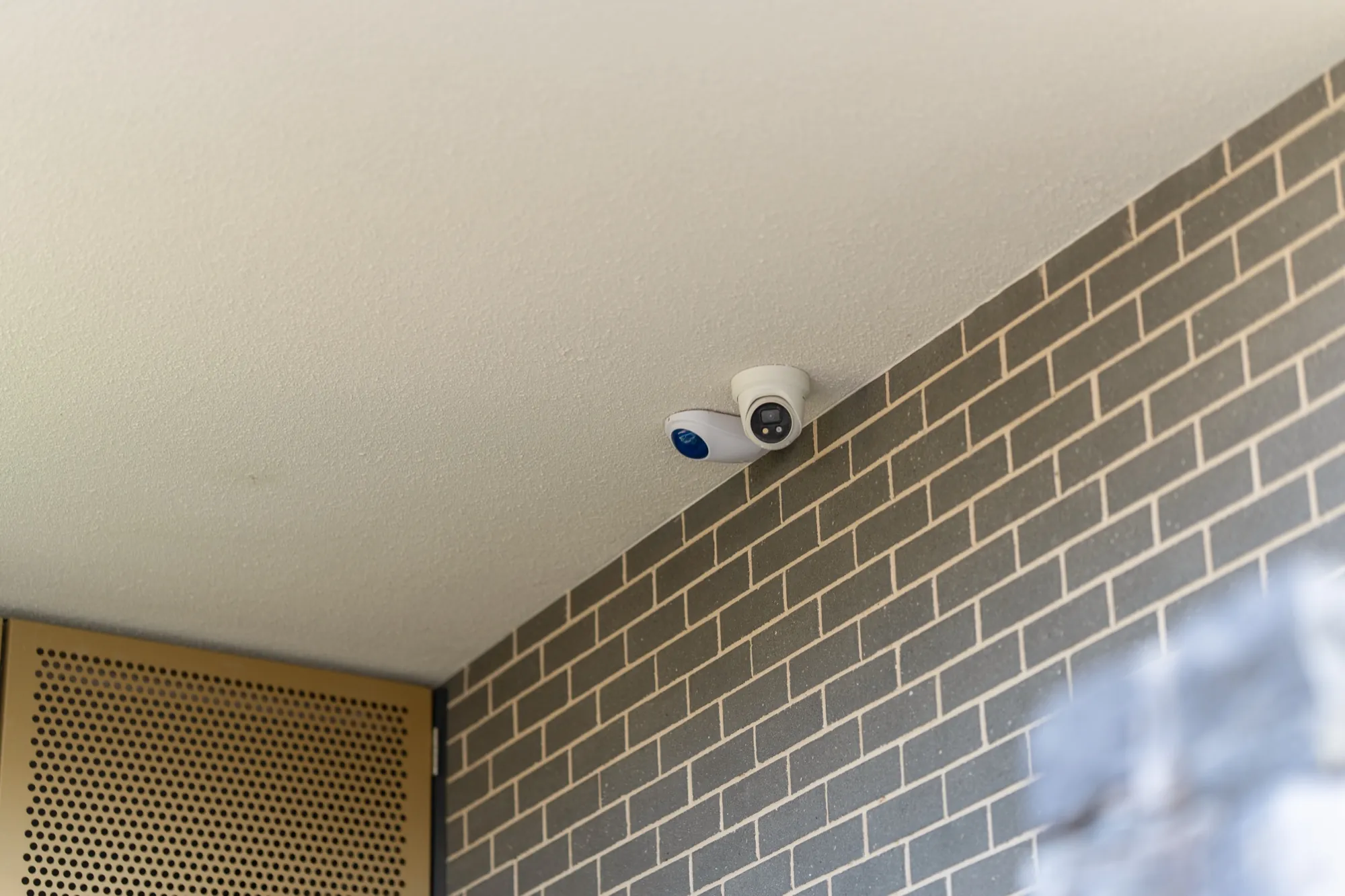 Security cameras installed on the brick wall of the Hackett new build