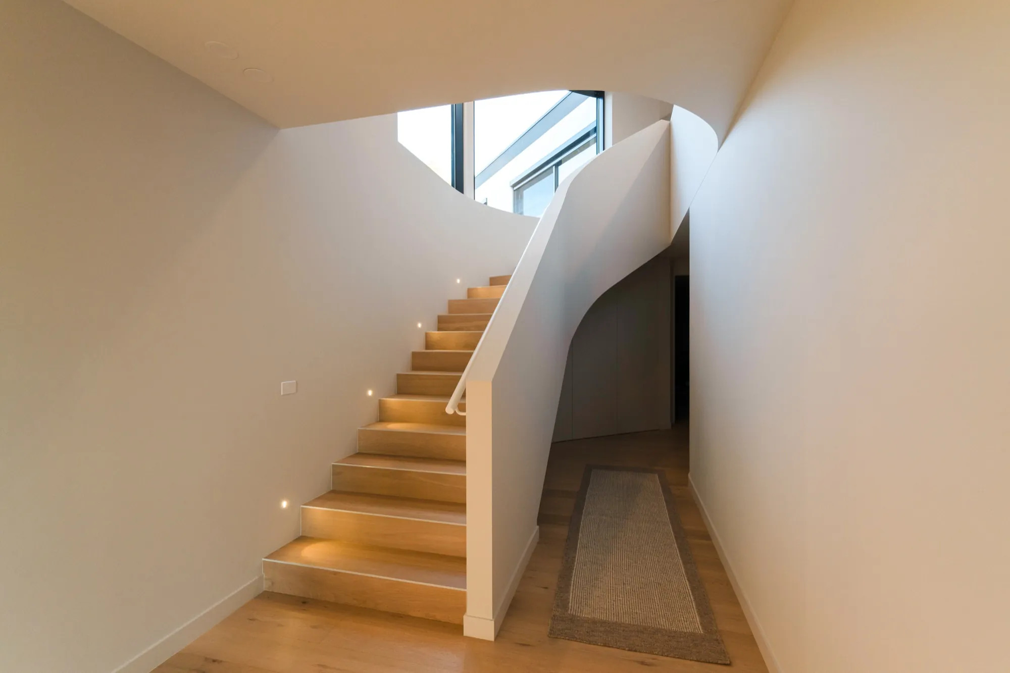 Staircase at the Hackett new build lit with recessed step lights