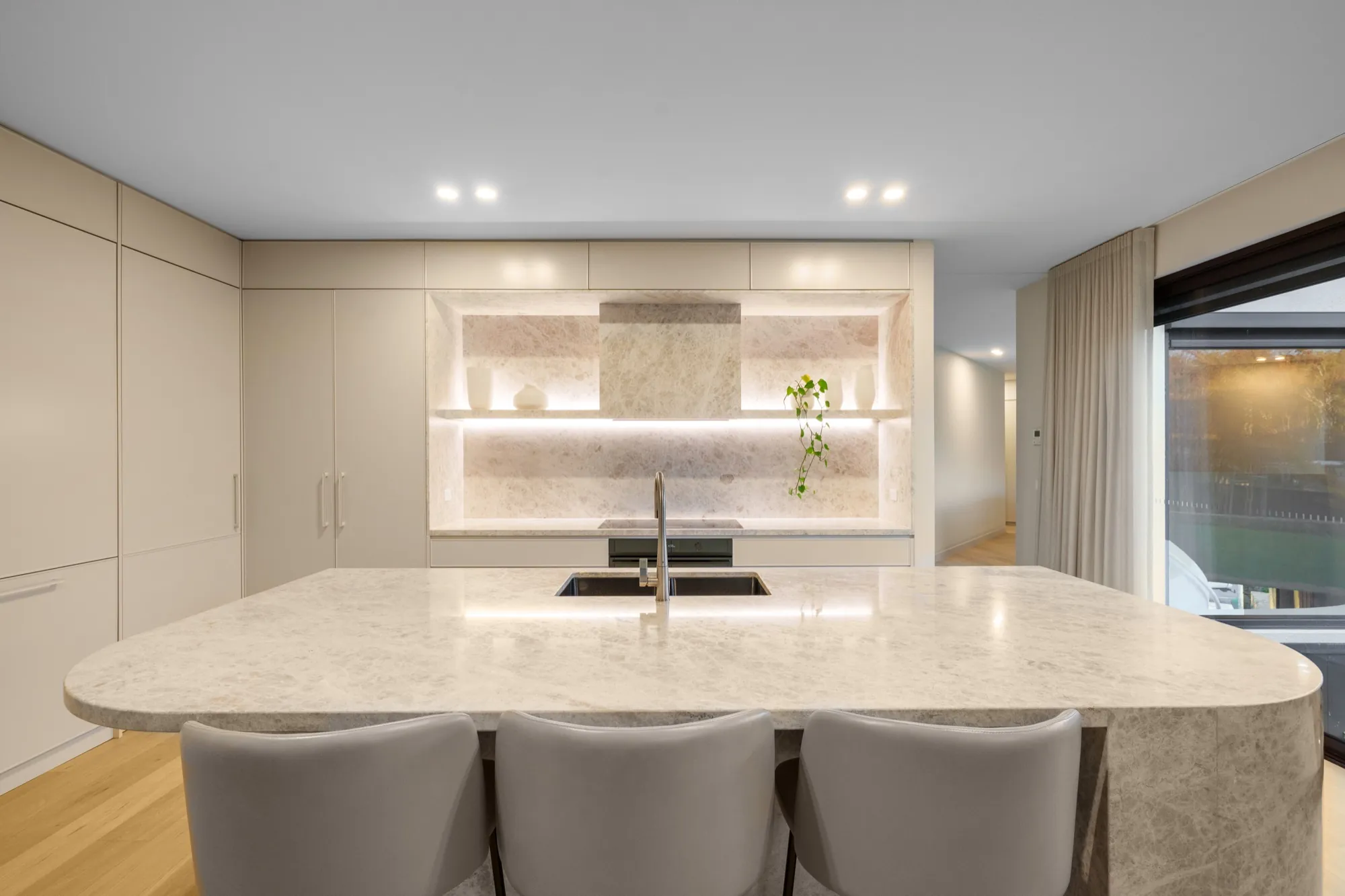 Hackett kitchen with stone island bench, shelf strip lighting and under-cabinet lighting