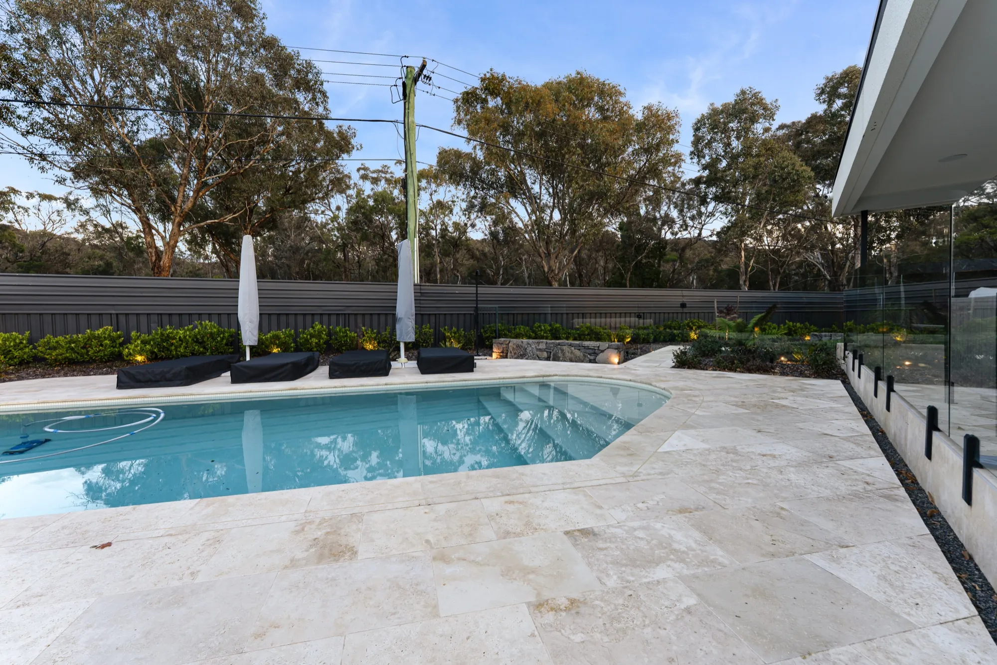 Swimming pool and glass fencing at the Hackett new build in daylight
