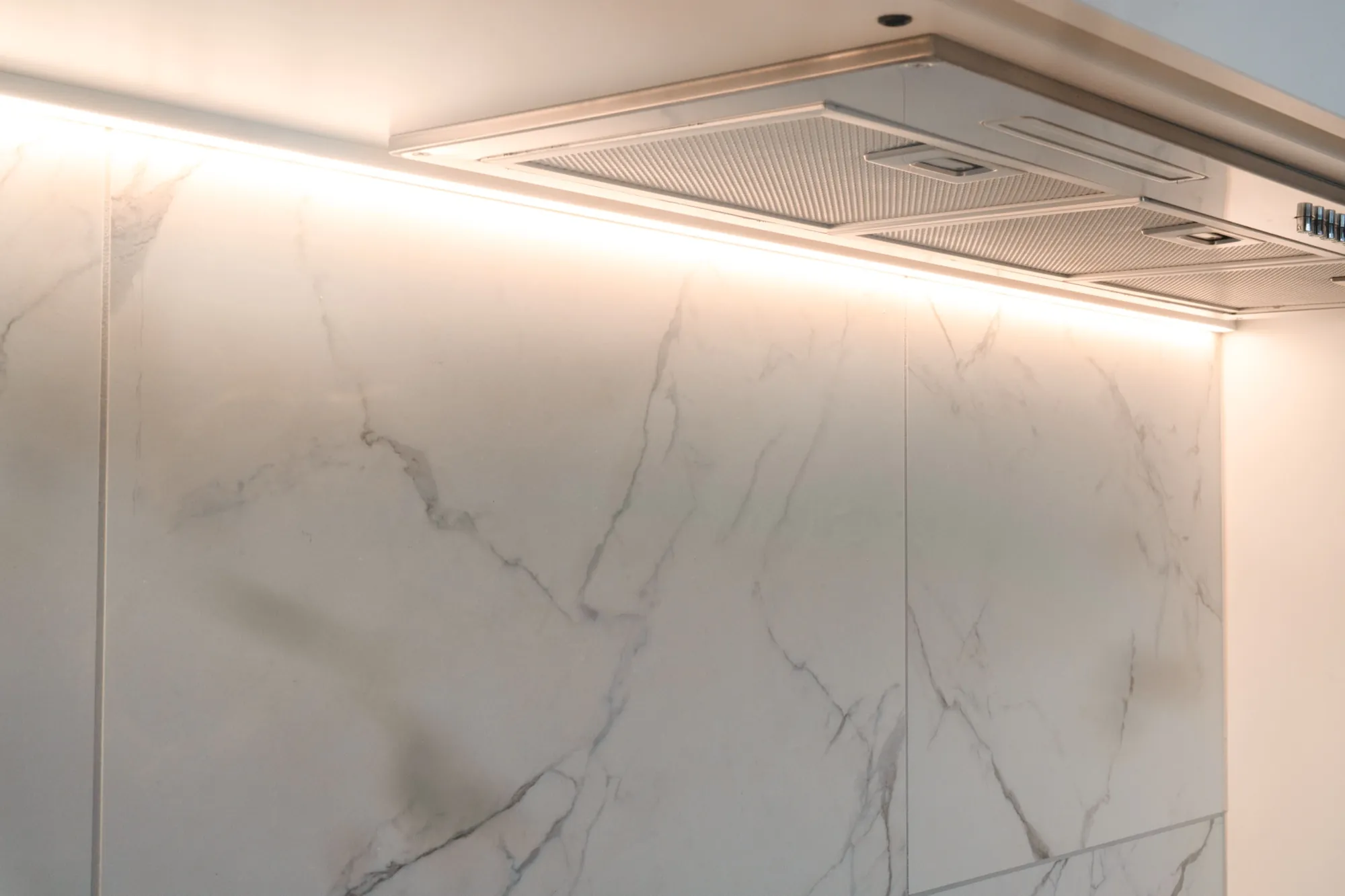 Rangehood and marble splashback in the second Phillip apartment with strip lighting on