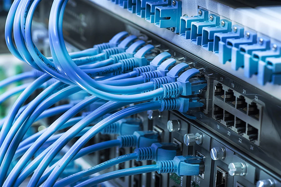 Patch panel and network switch neatly cabled in a comms rack